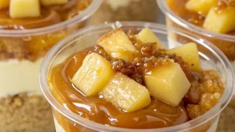 Delicious caramel apple dessert cups topped with whipped cream and caramel drizzle