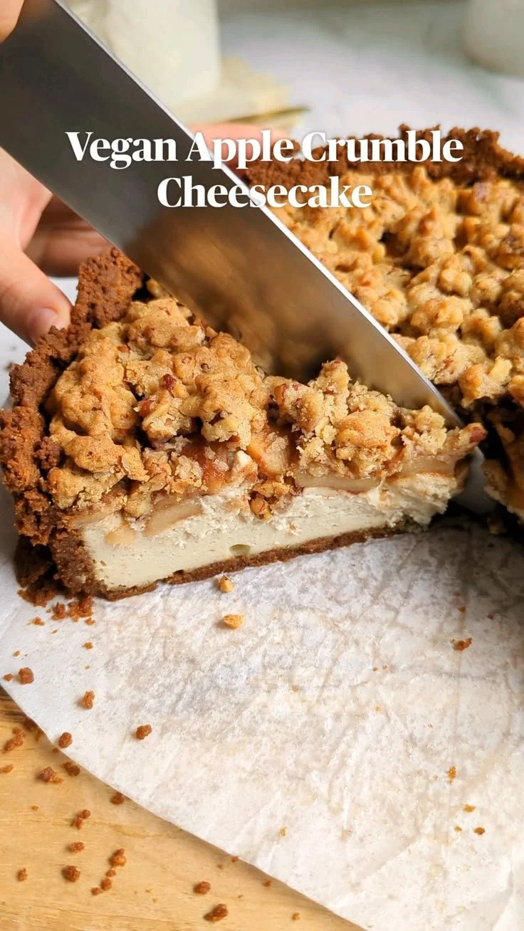 Vegan apple crumble cheesecake topped with crunchy crumble and apple slices