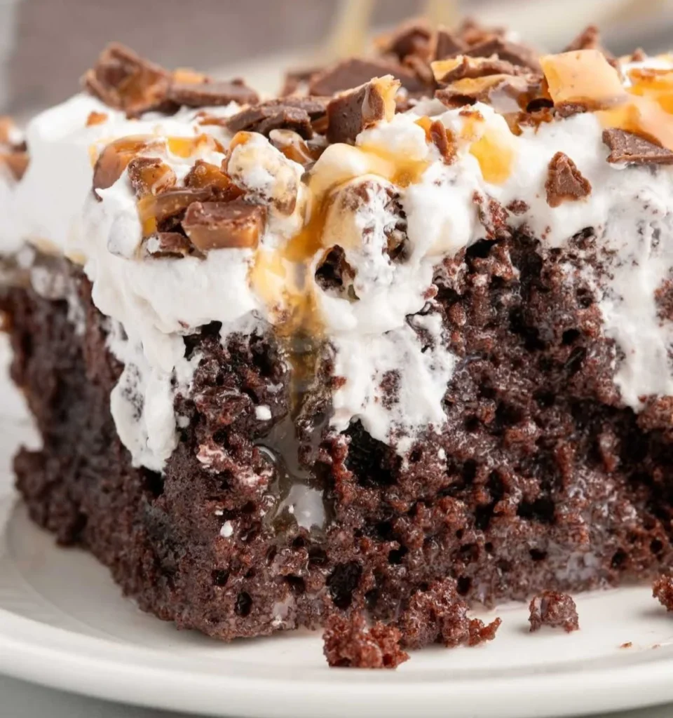 Delicious slice of Better Than Sex Cake topped with chocolate and caramel