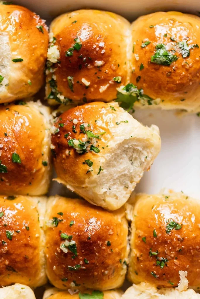 Freshly baked garlic bread rolls with herbs and butter