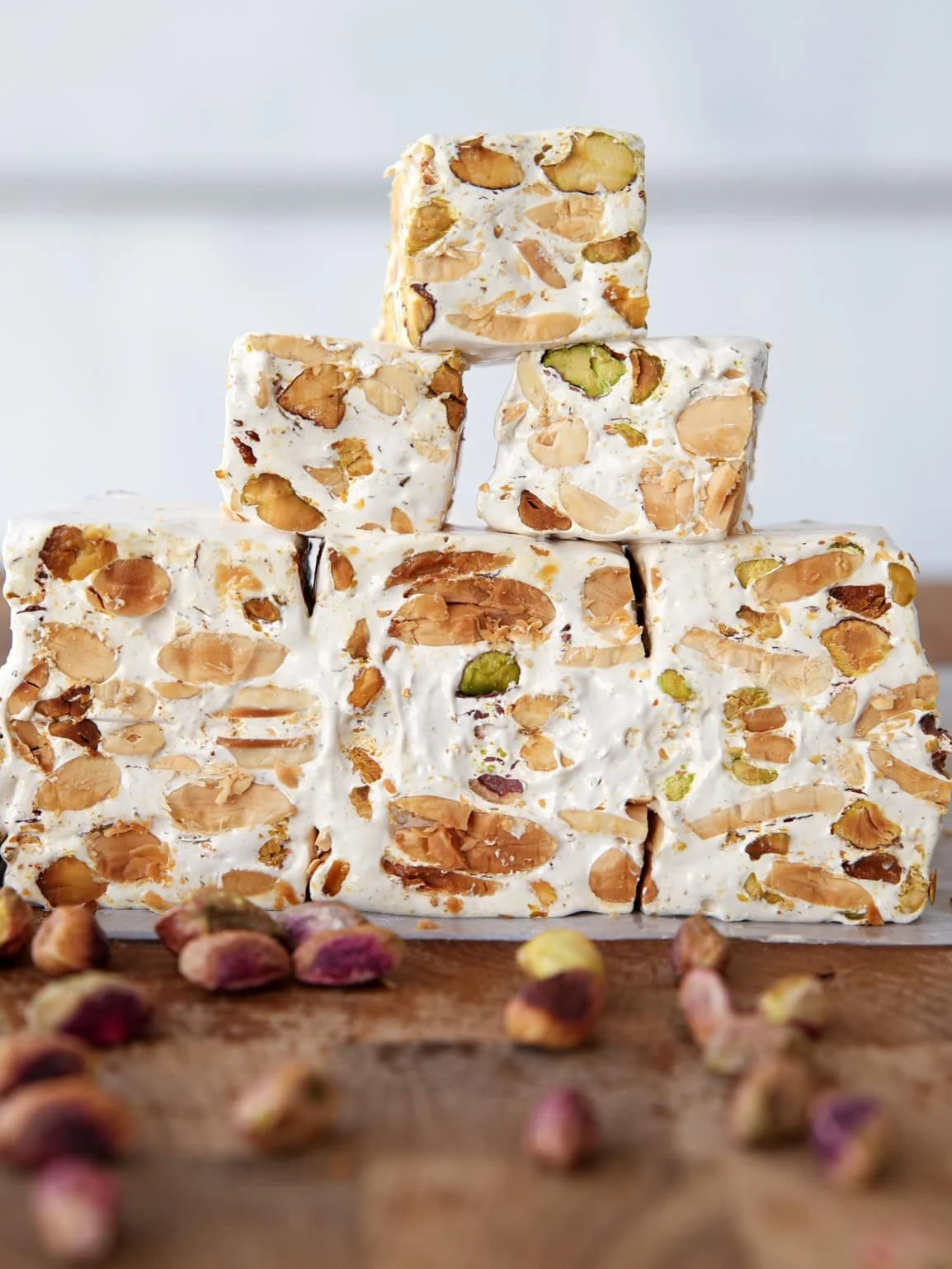 Homemade torrone recipe with nuts and honey in a festive setting.