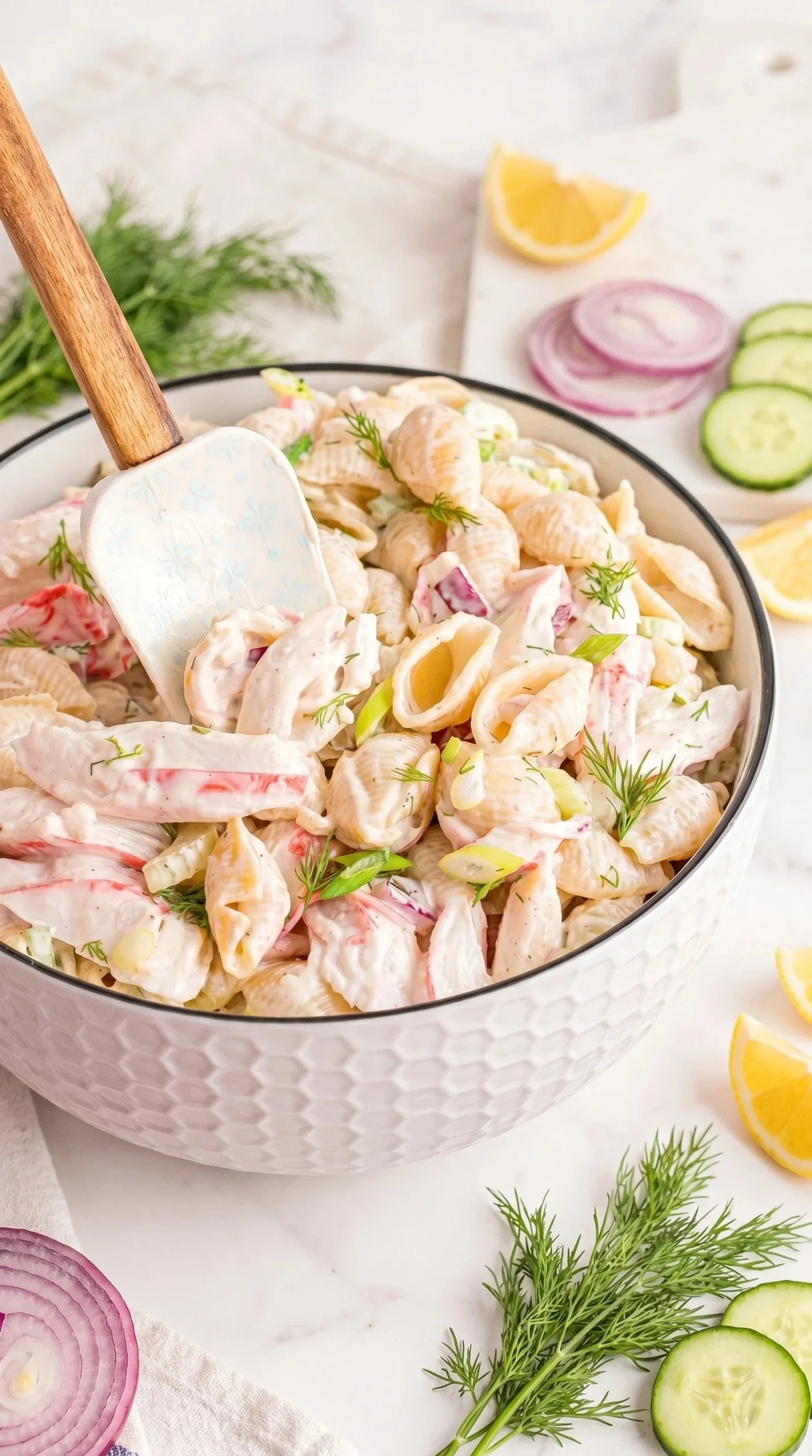Delicious crab pasta salad served in a bowl with fresh vegetables