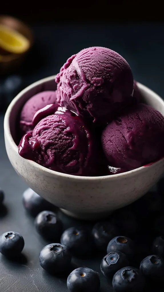 No churn blueberry lemon sorbet in a bowl garnished with fresh blueberries