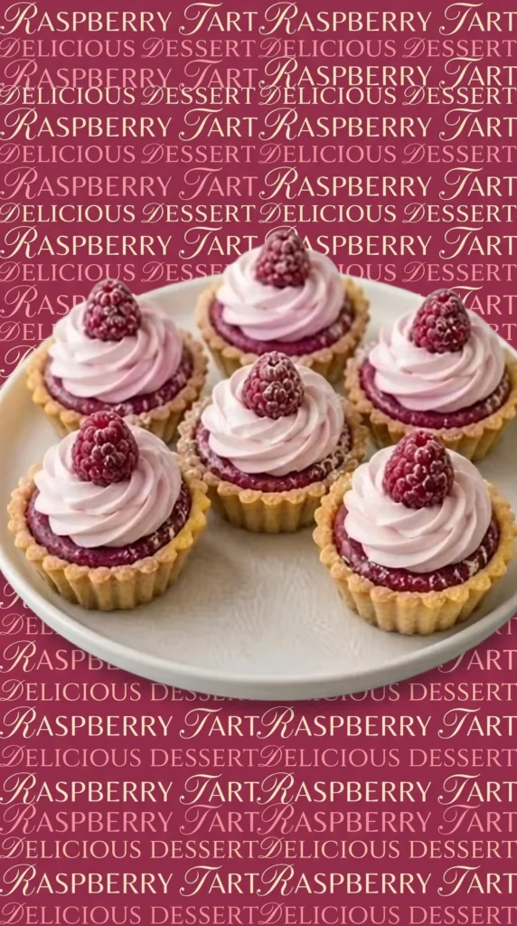 A delightful plate of raspberry cream tartlets topped with fresh raspberries.